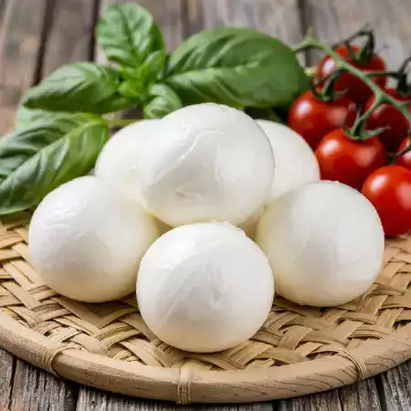 Fresh mozzarella cheese with stretchy texture made daily at VillageCheese workshop using traditional Italian techniques
