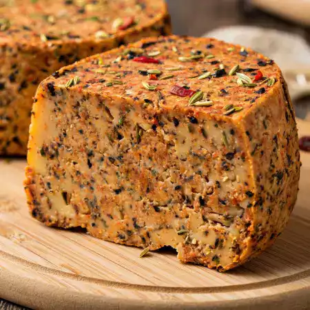 Aromatic herb-infused cheese with fresh basil oregano and thyme made at VillageCheese using premium ingredients