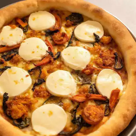 Gujarati-style fusion cheese pizza with VillageCheese fresh mozzarella and spiced paneer on traditional base